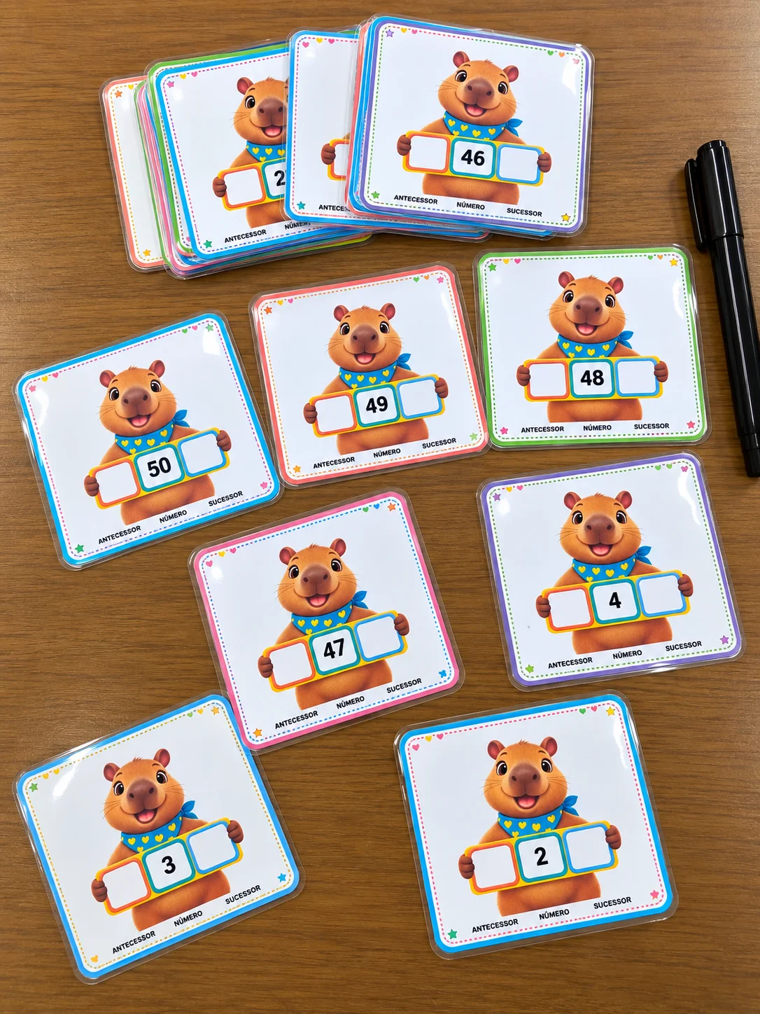 CARDS ANTECESSOR E SUCESSOR – CAPIVARINHA 🌟 — amostra 1: Números de 1 a 50 ✏️ A criança completa o antecessor e o sucessor…
